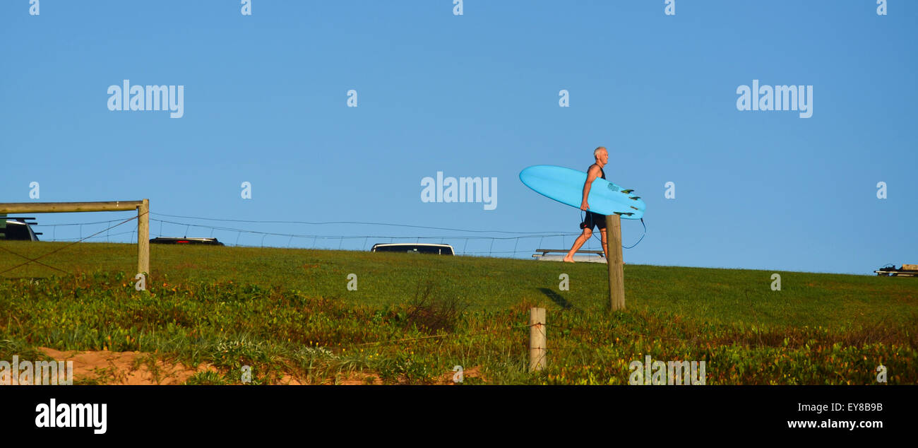 Ein älterer Surfbrettfahrer geht zum Strand am Palm Beach in Sydney in New South Wales, Australien Stockfoto