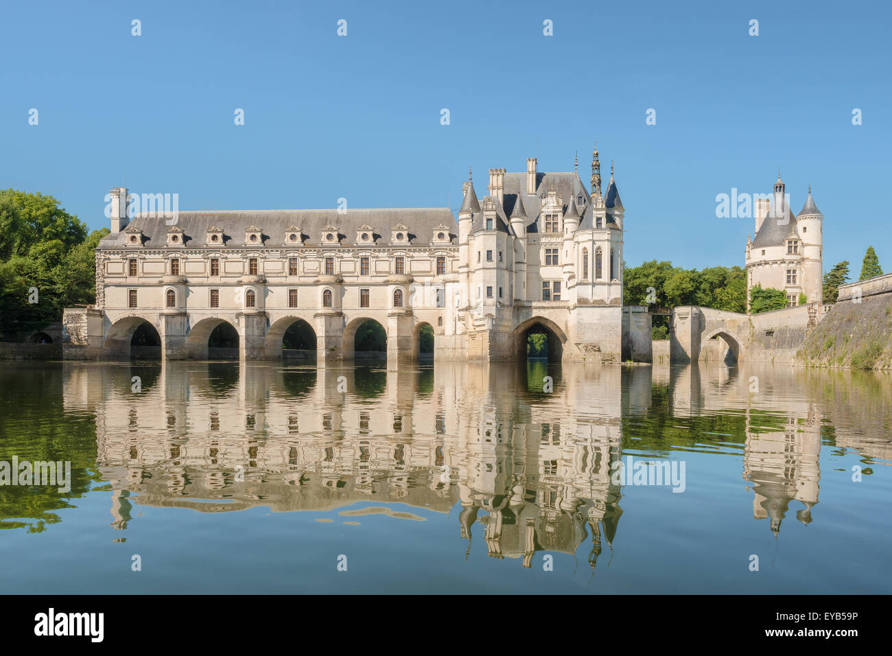 Schloss Chenonceau, errichtet über den Fluss Cher, Loiretal, Frankreich, Blick aus dem Fluss auf Farbverlauf blauer Himmelshintergrund. Stockfoto