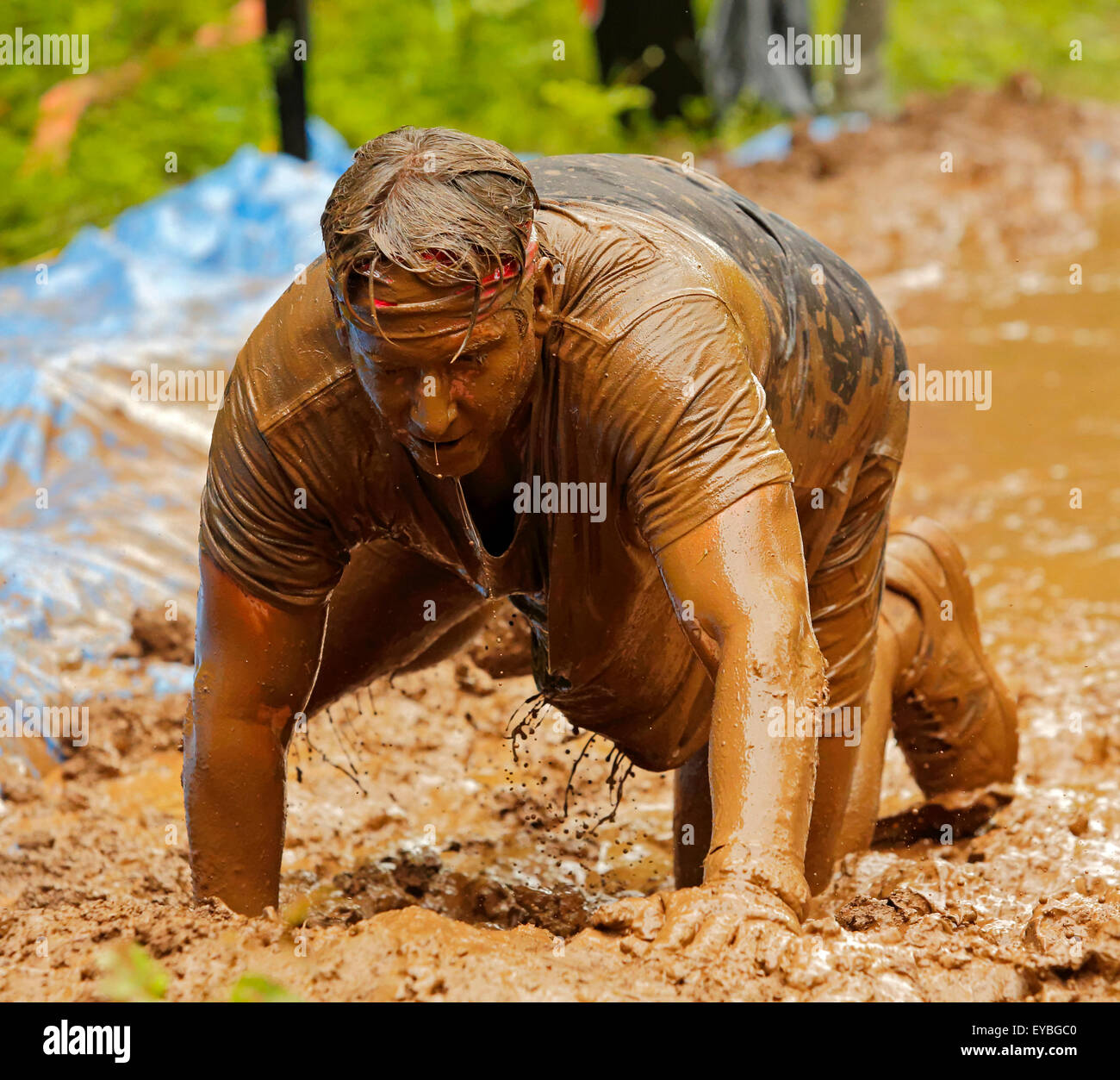 Teilnehmer mussten runter auf Händen und Knien für diese Station in der Mud Run für Herz 25. Juli 2015, Waterford, Kanada Stockfoto