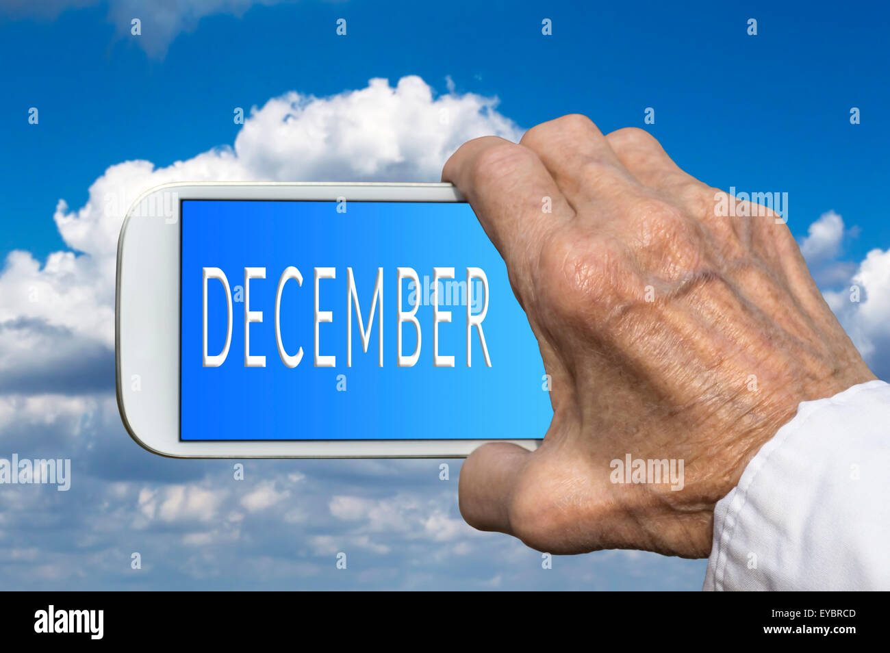 Das Smartphone im Alter Hase mit Monat des Jahres - Dezember auf dem Bildschirm. Selektiven Fokus. Stockfoto