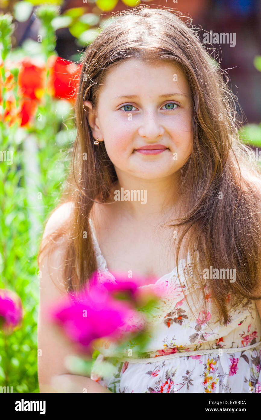 Porträt eines 10 Jahre alten Mädchens den Blumengarten zu Hause genießen. Stockfoto