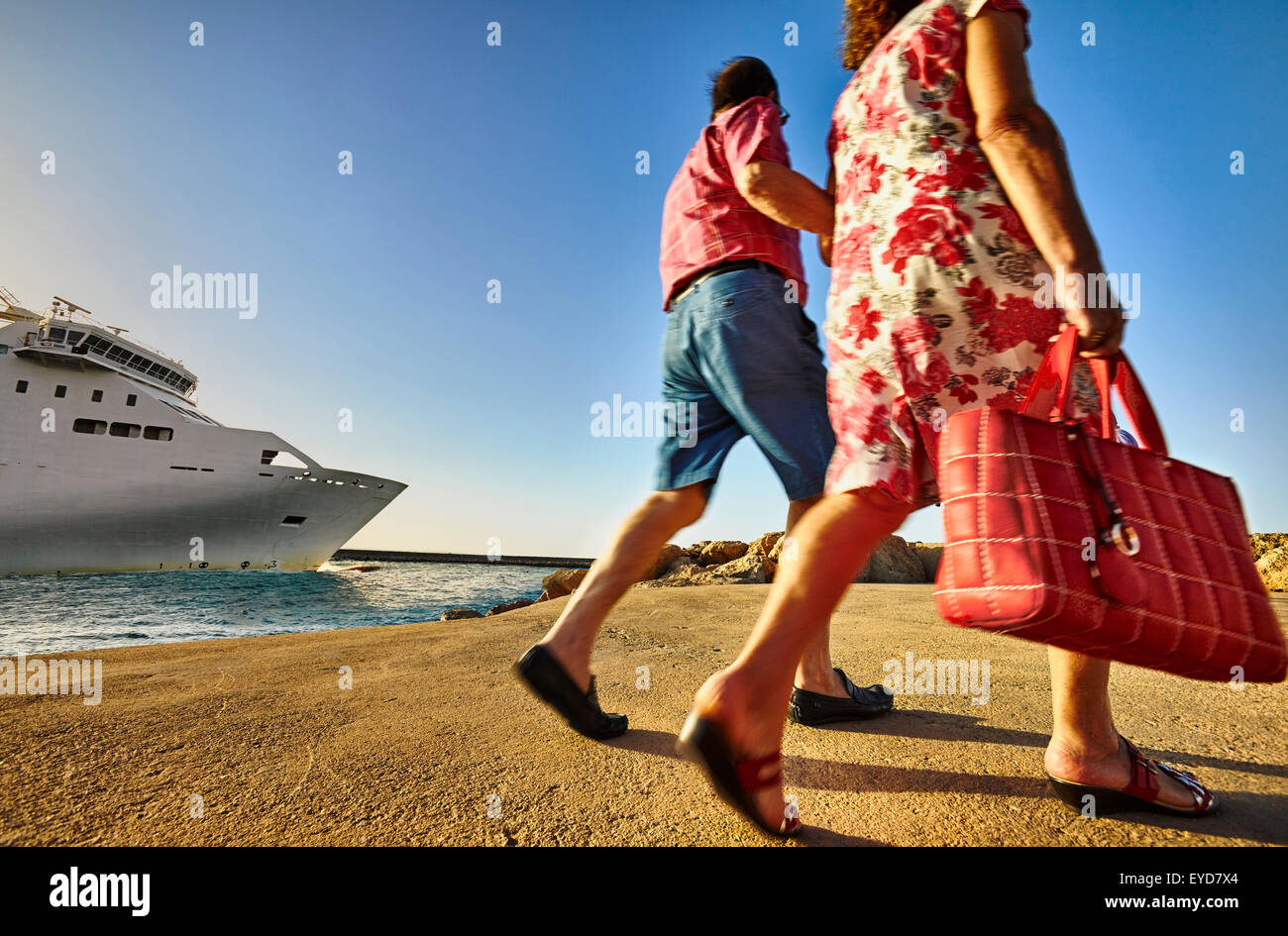 People walking by the seafront promenade at the harbour. Denia. Alicante. Valencia Community. Spain Stockfoto
