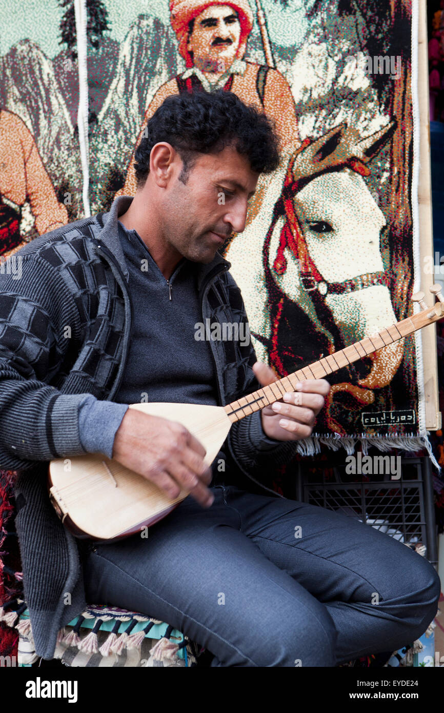 Männliche Souvenir-Verkäufer spielen Musikinstrument auf Zitadelle In Erbil, irakische Kurdistan, Irak Stockfoto