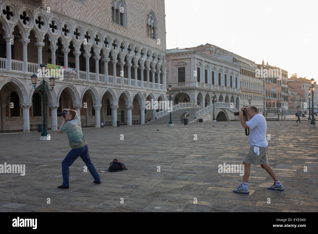 Fotografen beugen ihre Knie vor dem Dogenpalast in Piazza San Marco, Venedig, Italien. Stockfoto