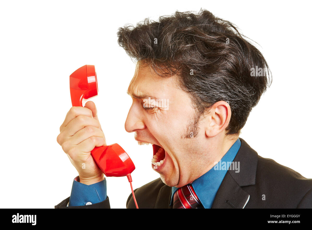 Wütend Geschäftsmann laut schreiend in einem roten Telefonhörer Stockfoto
