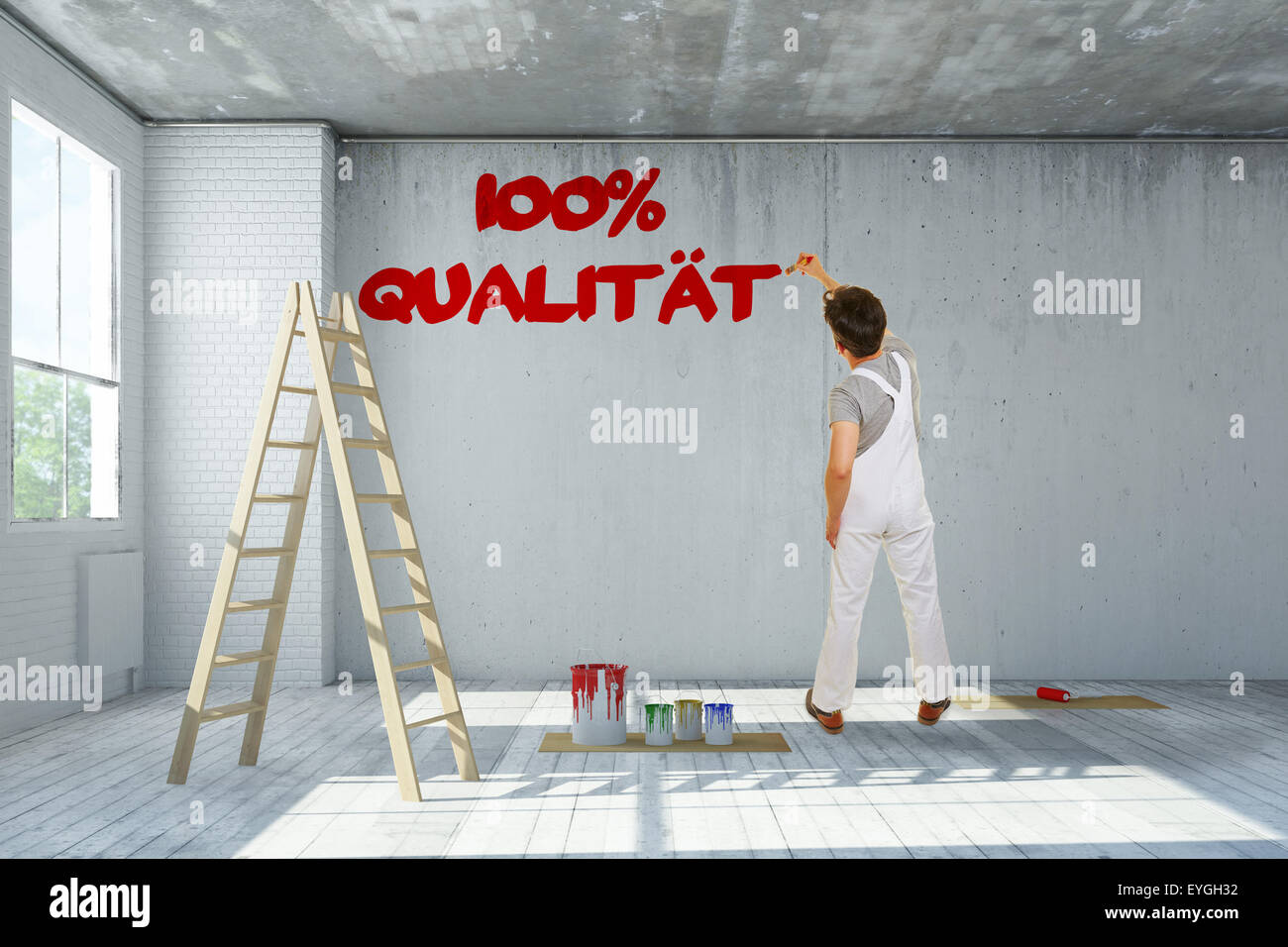 Maler, schreiben deutsche Motto 100 % Qualitaet "(100 % Qualität) an einer Wand Stockfoto