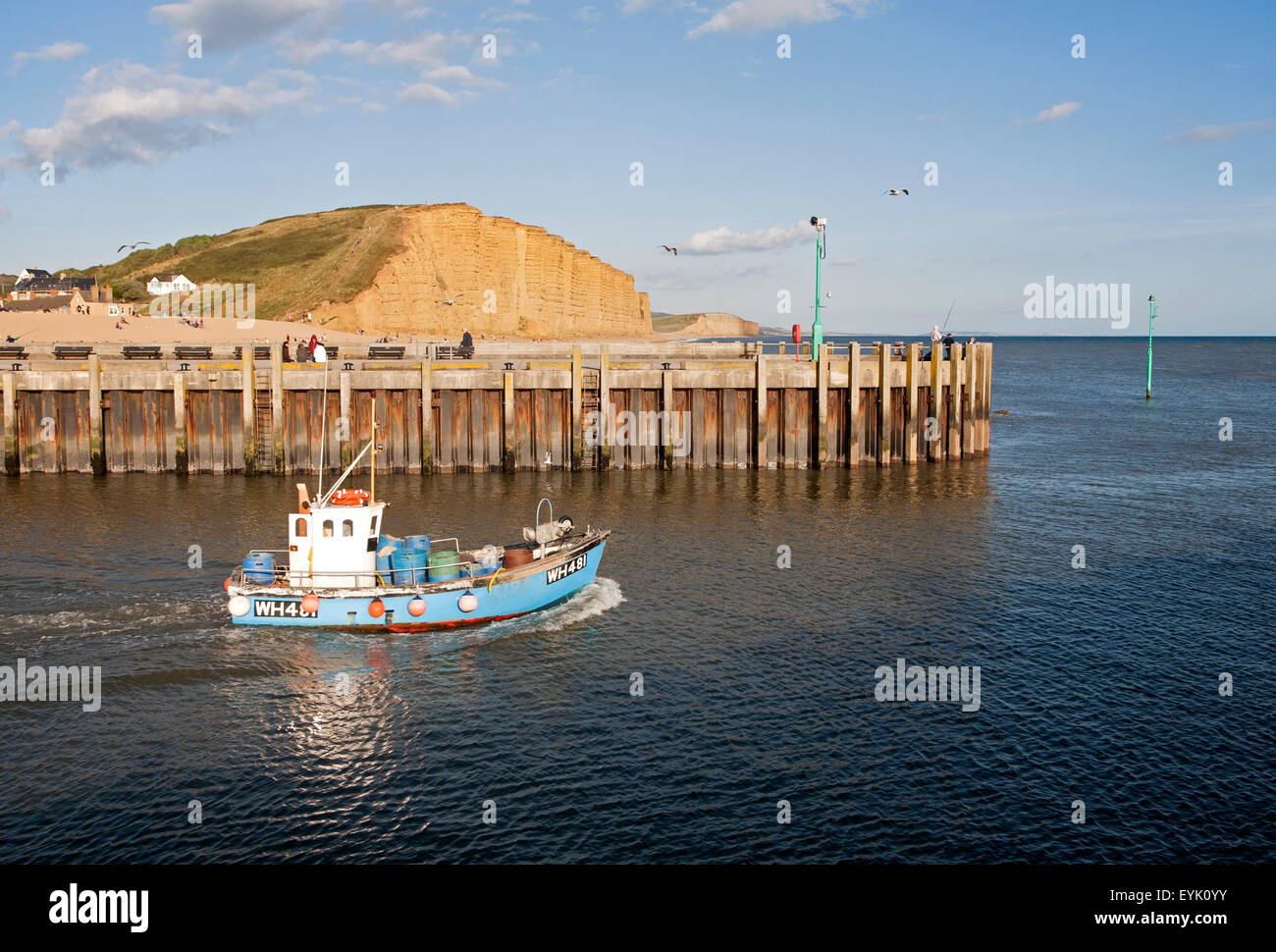 Kleines Fischerboot verlassen den Hafen von West Bay, Bridport, Dorset, England, UK Stockfoto