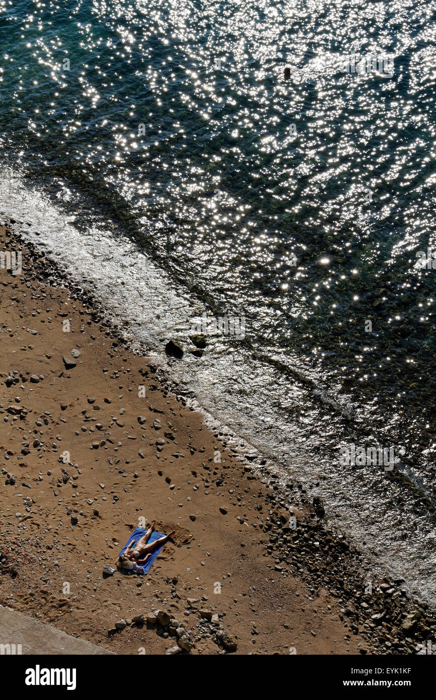 Frau liegen auf einem Strand sonnen, von oben Stockfoto
