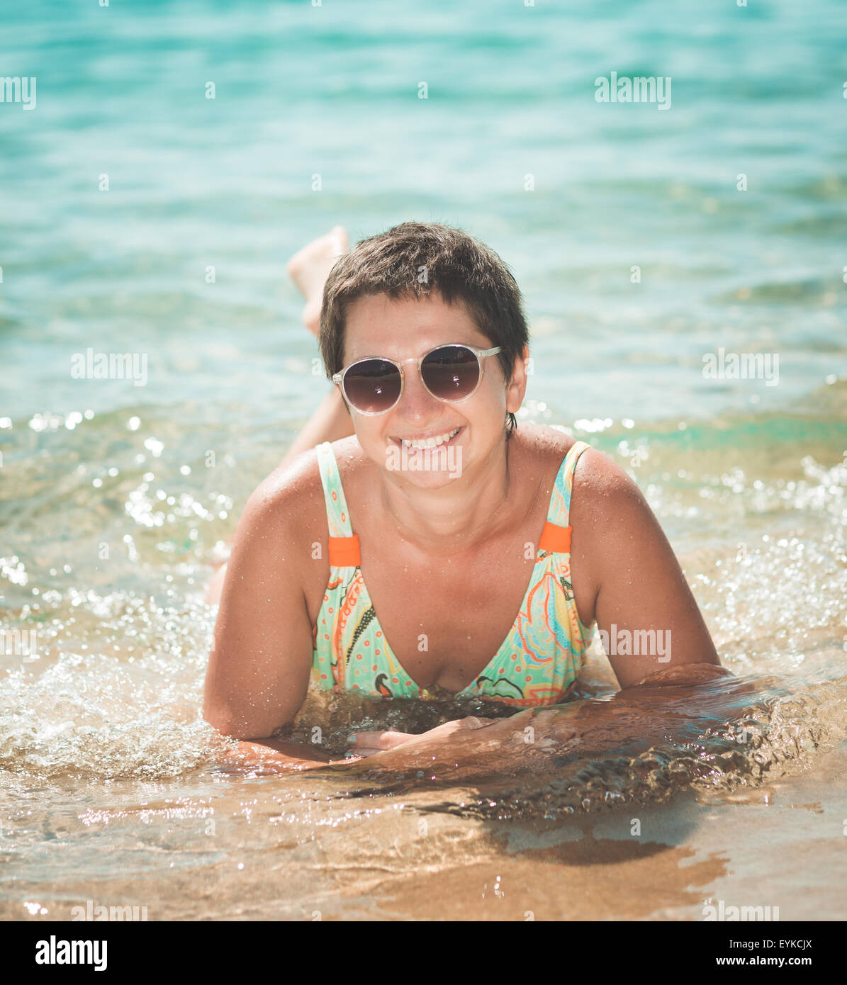 Glückliche Frau in einem Meer Stockfoto