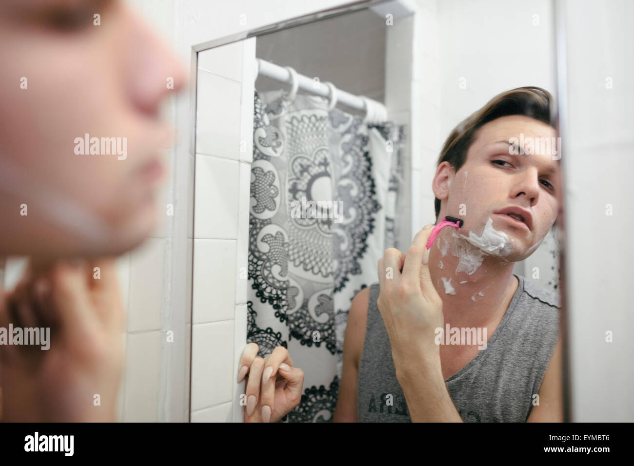 Männliche Dragqueen rasieren vor dem Aufstellen auf und putzt sich in Vorbereitung auf eine Leistung Stockfoto