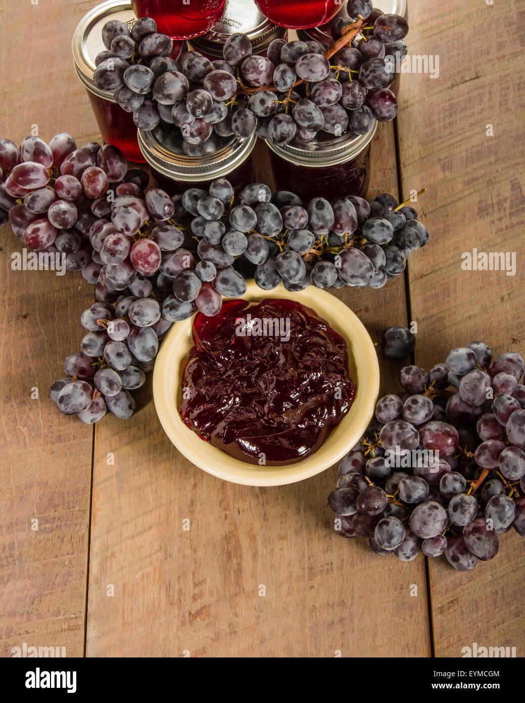 Schüssel mit Traubengelee mit Trauben und Gläser Stockfoto