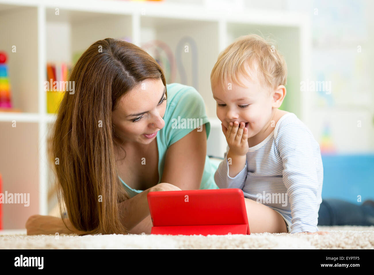 Familie - Mutter und Sohn mit Tablet im Stock zu Hause. Frau und Kind entspannend auf Tablet-Computer. Stockfoto