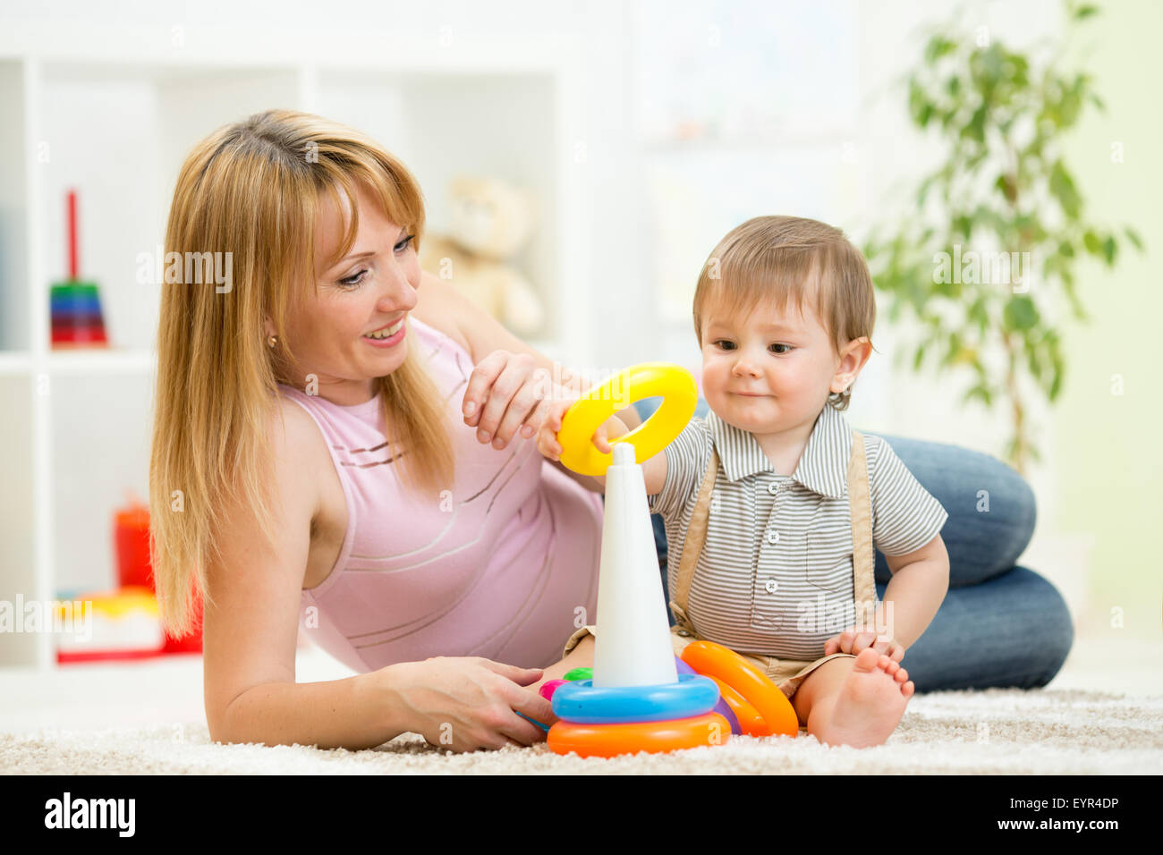 Kind und Frau spielen zusammen im Kindergarten Stockfoto