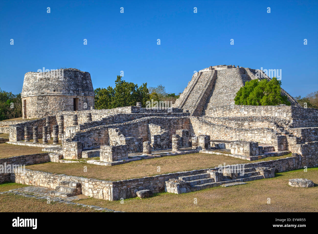 Runde Tempel nach links auf der Rückseite und Castillo de Kukulcan zur rechten, Mayapan, Maya-Ausgrabungsstätte, Yucatan, Mexiko Stockfoto
