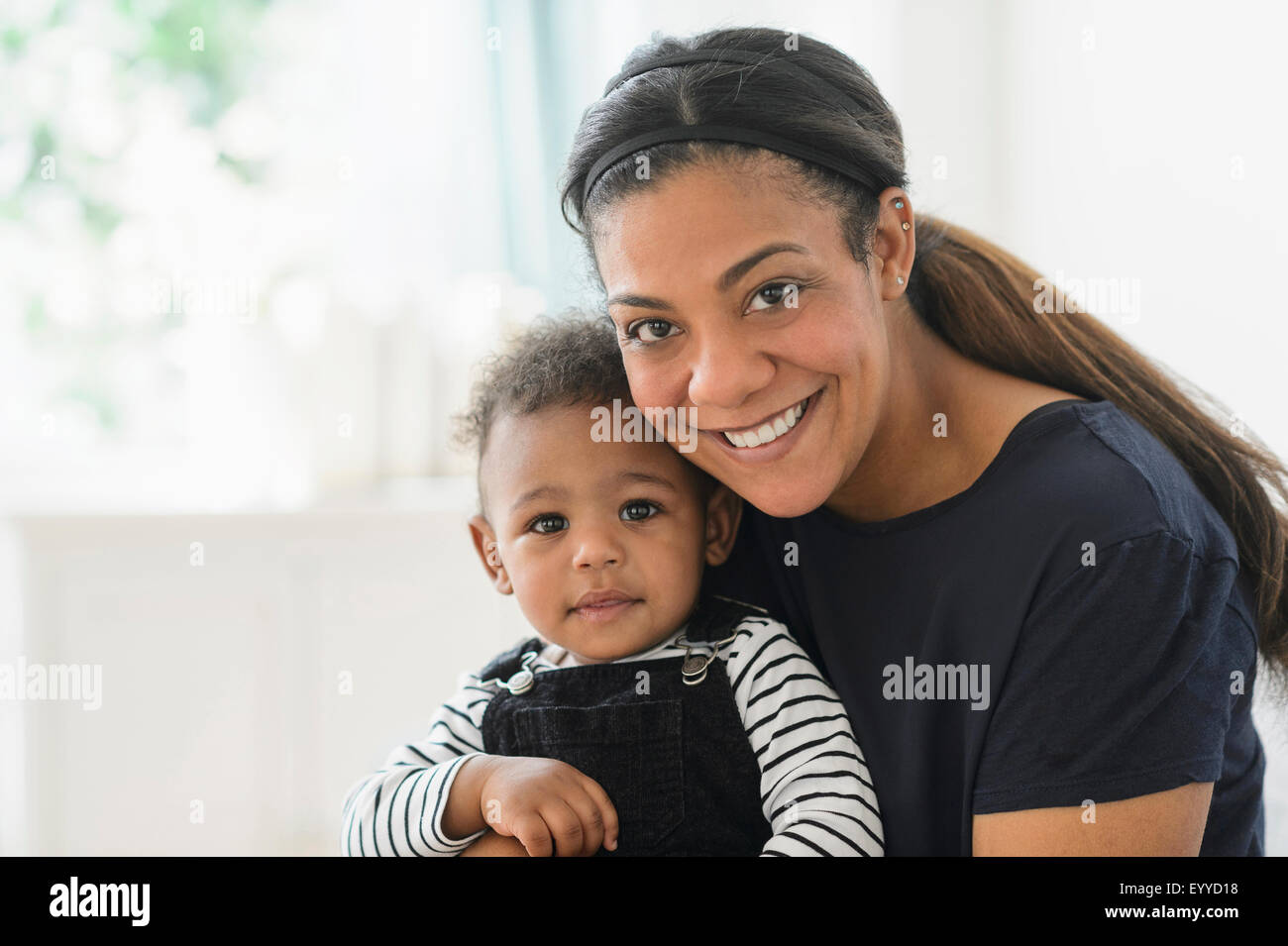 Mischlinge Mutter mit Baby Sohn im Wohnzimmer Stockfoto