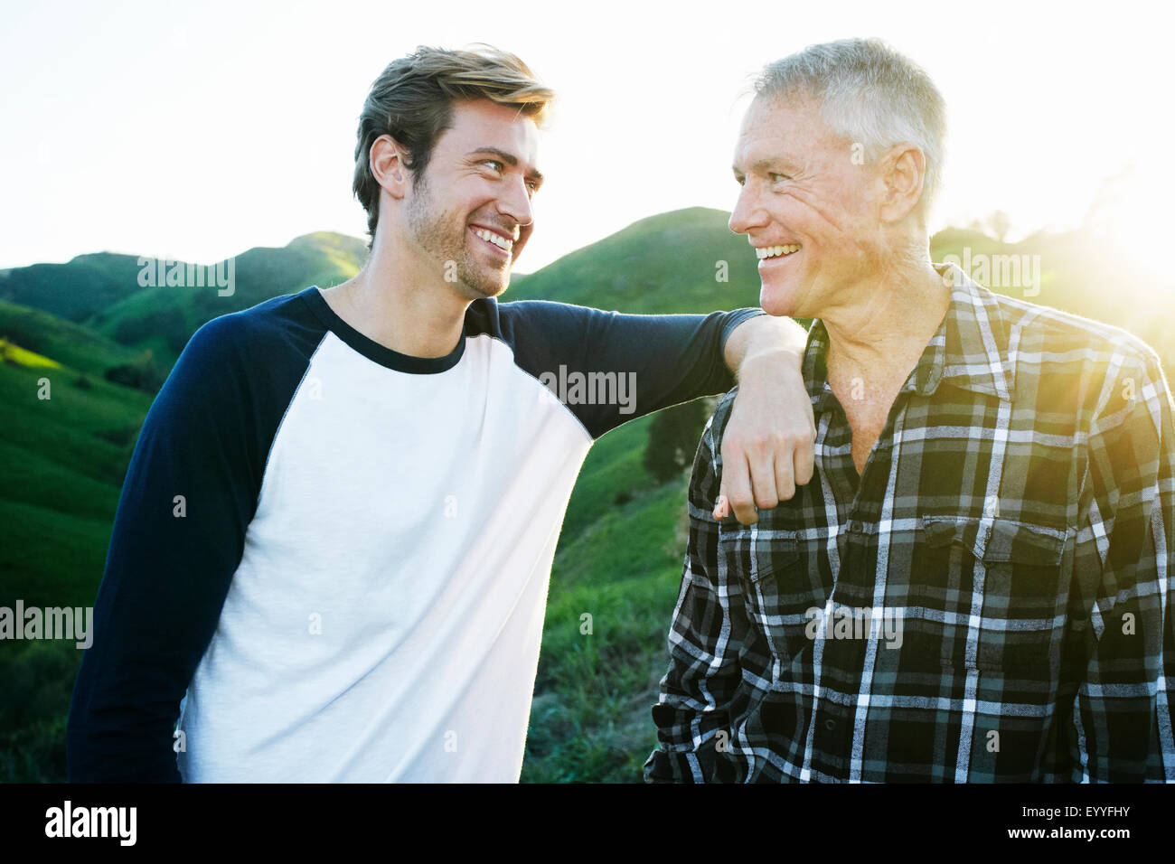 Kaukasische Vater und Sohn lächelnd auf ländlichen Hügel Stockfoto