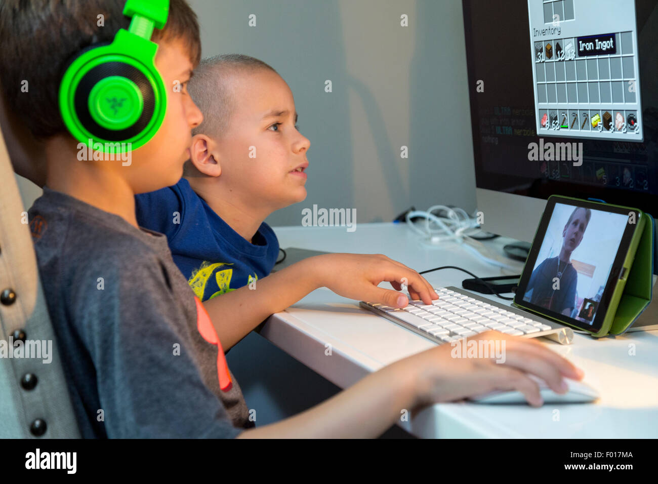 Zwei Jungs, ein Video-Spiel mit einem Freund per Facetime zu kommunizieren.  HERR Stockfoto