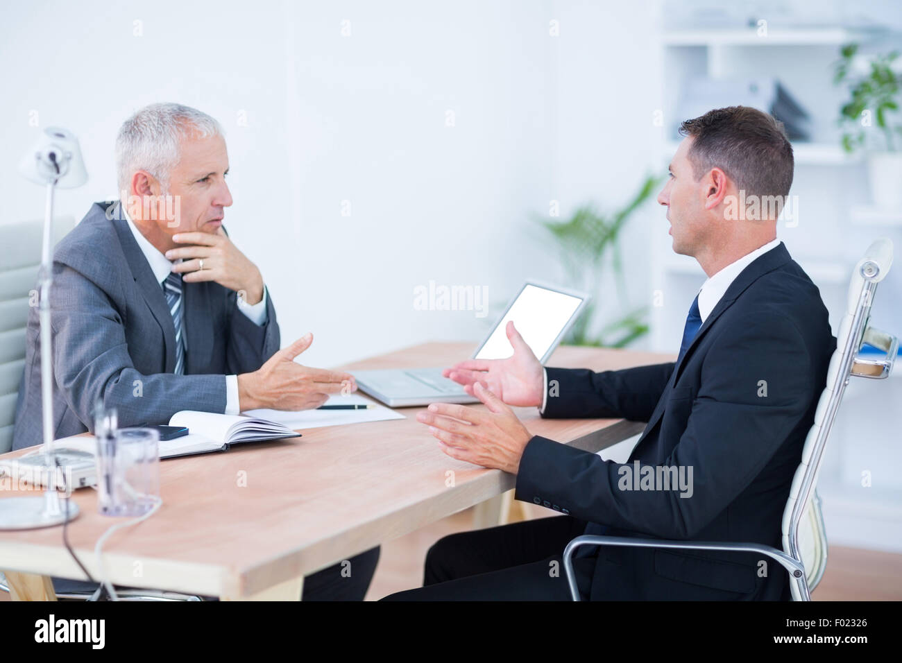 Zwei schwere Geschäftsleute sprechen und arbeiten Stockfoto