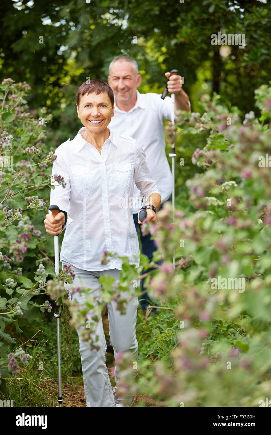 Gerne älteres paar Nordic-walking im Wald zu tun Stockfoto