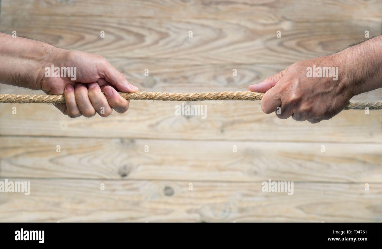 Seil ziehen an einem hölzernen Hintergrund. Stockfoto