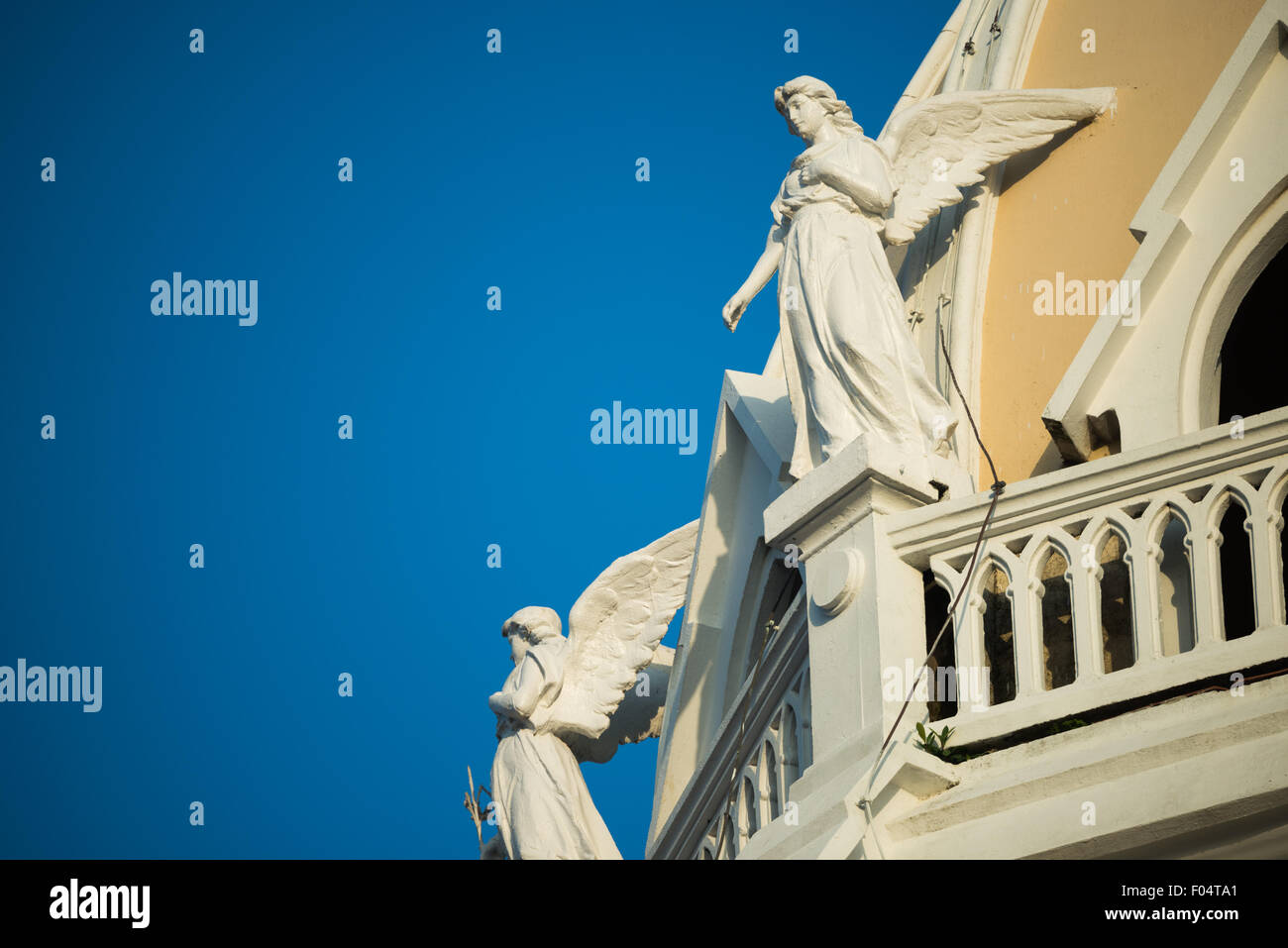Iglesia San Francisco de Asis Engelskulpturen Panama-STADT // PANAMA-STADT, Panama — Engelskulpturen zieren den Turm der historischen Iglesia San Francisco de Asis im Stadtteil Casco Viejo von Panama City. Die Kirche aus der Kolonialzeit, die gegenüber der Plaza Bolivar liegt, wurde Mitte der 1700er Jahre zweimal durch einen Brand zerstört, bevor sie wieder aufgebaut wurde. Dieses architektonische Wahrzeichen befindet sich gegenüber dem Nationaltheater am Ufer und stellt einen wichtigen Teil des religiösen und kulturellen Erbes Panamas im von der UNESCO ausgewiesenen historischen Viertel dar. Stockfoto