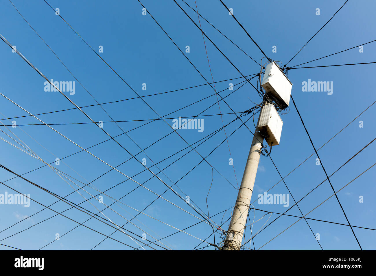 Strommast mit weißen Felder mit vielen elektrischen Leitungen in Nachbarschaft der Zigeuner in Sofia, Bulgarien. Stockfoto
