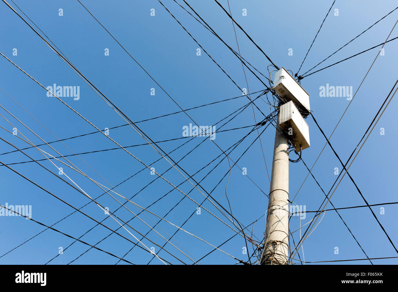 Strommast mit weißen Felder mit vielen elektrischen Leitungen in Nachbarschaft der Zigeuner in Sofia, Bulgarien. Stockfoto
