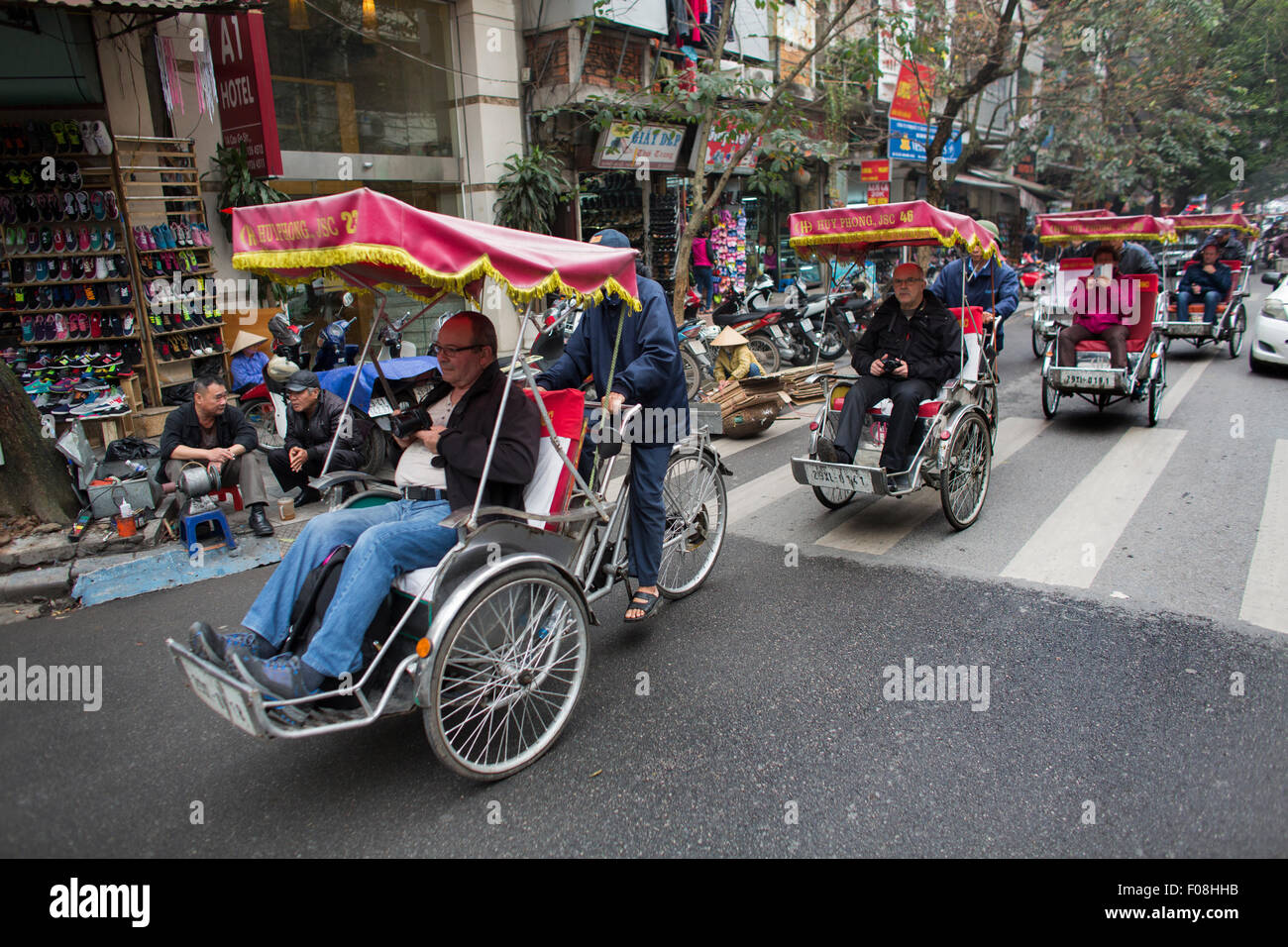 Touristen, die Touren rund um in Dreiräder in Hanoi Stockfoto