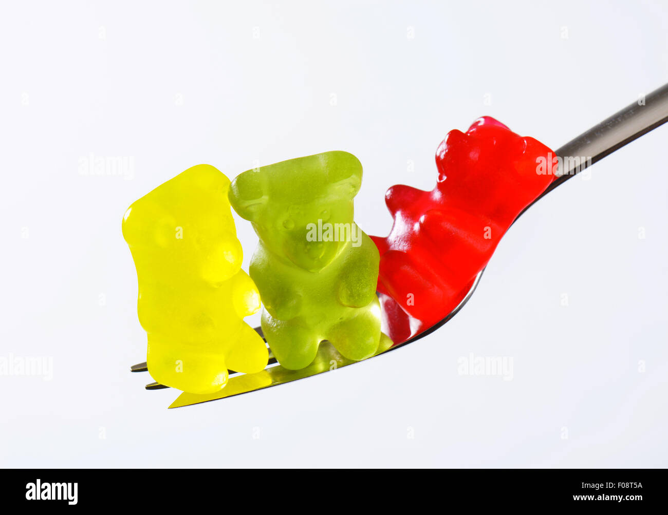 Drei Gummibärchen auf einer Gabel Stockfoto