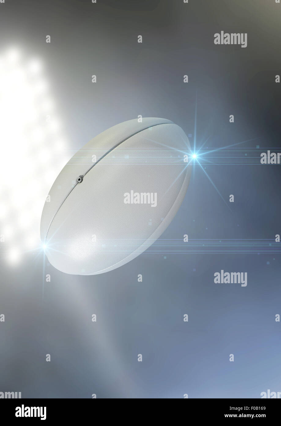 Eine regelmäßige Rugby-Ball fliegen durch die Luft auf ein Stadion Hintergrund während der Nacht Stockfoto