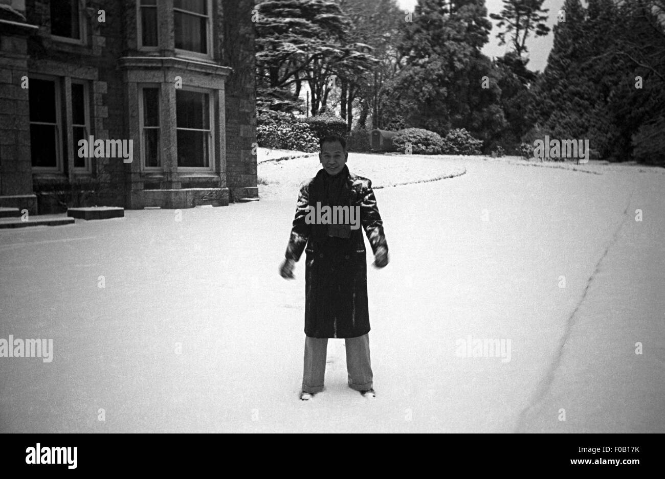 Ein Mann steht auf einer verschneiten Auffahrt Stockfoto