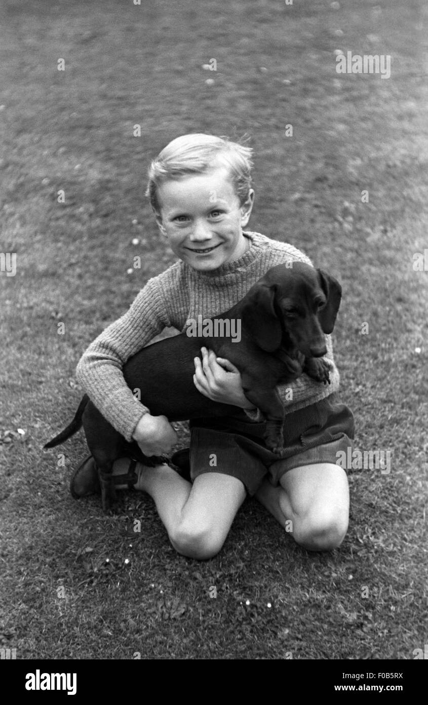 Ein kleiner Junge und sein Hund im Garten. Stockfoto