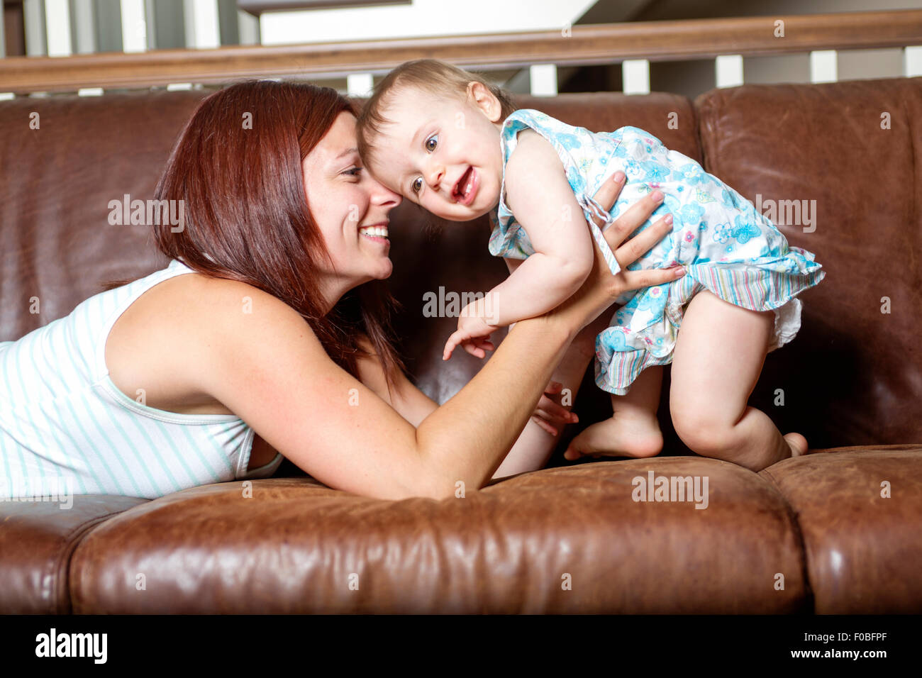 gerne schöne junge Mutter und Baby Verlegung auf sofa Stockfoto