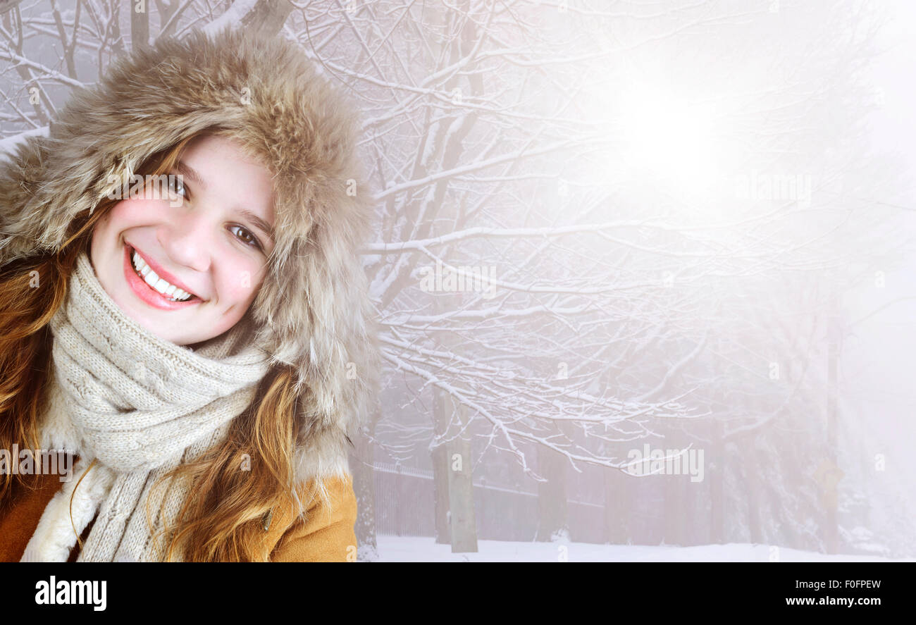 Schöne junge Frau in Fell Kapuze der Wintermantel außerhalb auf verschneiten Sonnentag mit Textfreiraum Stockfoto