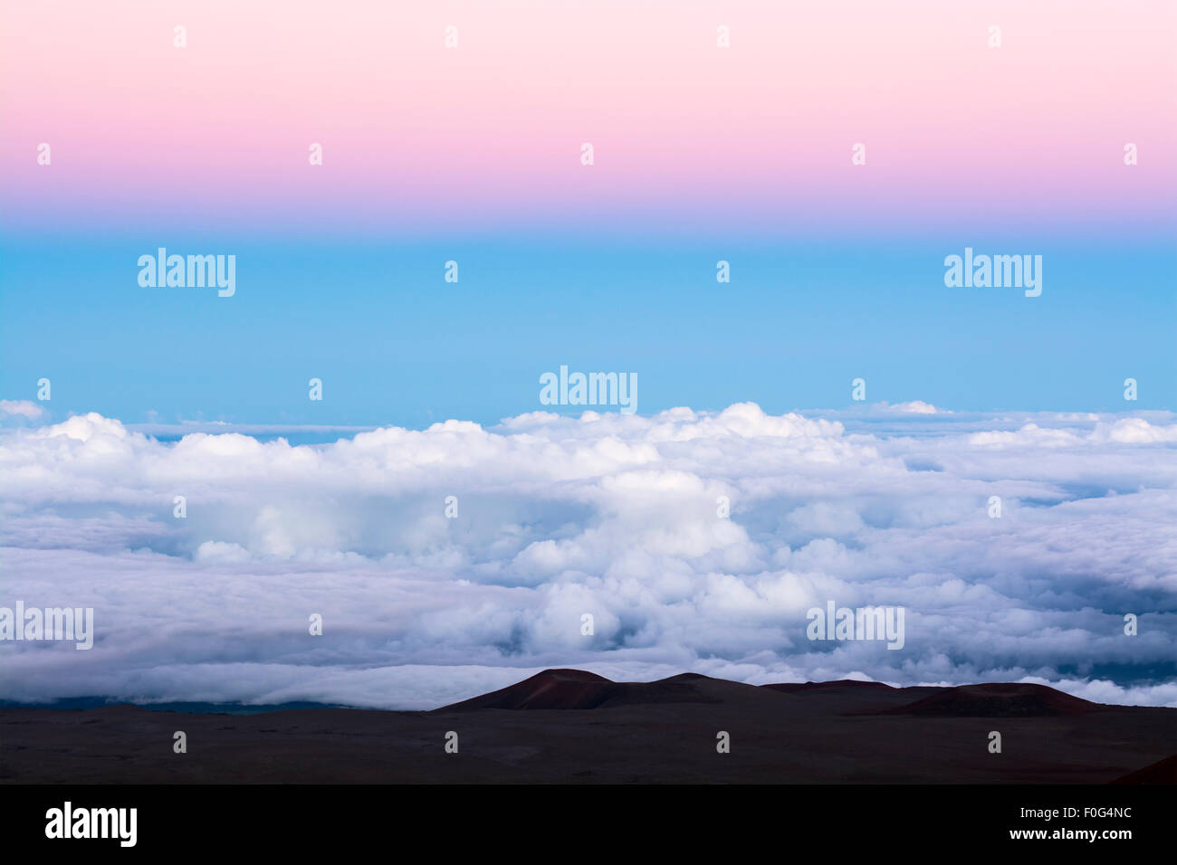 Ein klassisches rosa Inversionsschicht oben ein blauer Himmel bei 14.000 Fuß mit Blick auf die Oberseite der Wolken. Stockfoto
