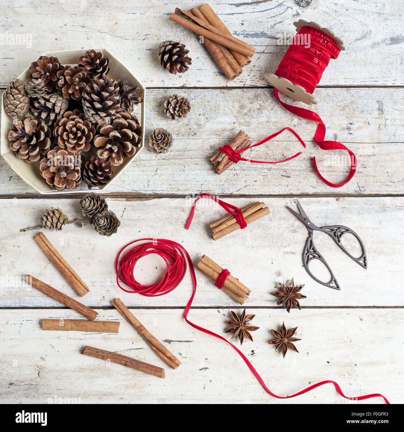 Tannenzapfen, Gewürze und Zimt Bündel gebunden mit rotem Band für Weihnachten Stockfoto