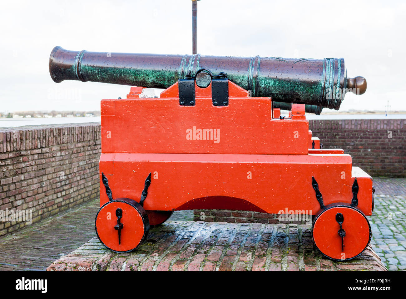 Dieser Kanon ist auf einer Basis in Richtung Meer Mauerwerk Stockfoto
