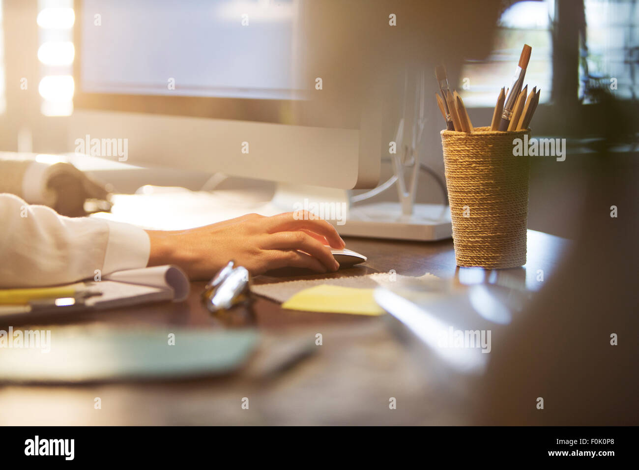Geschäftsfrau mit Computer und Computer-Maus am Schreibtisch Stockfoto