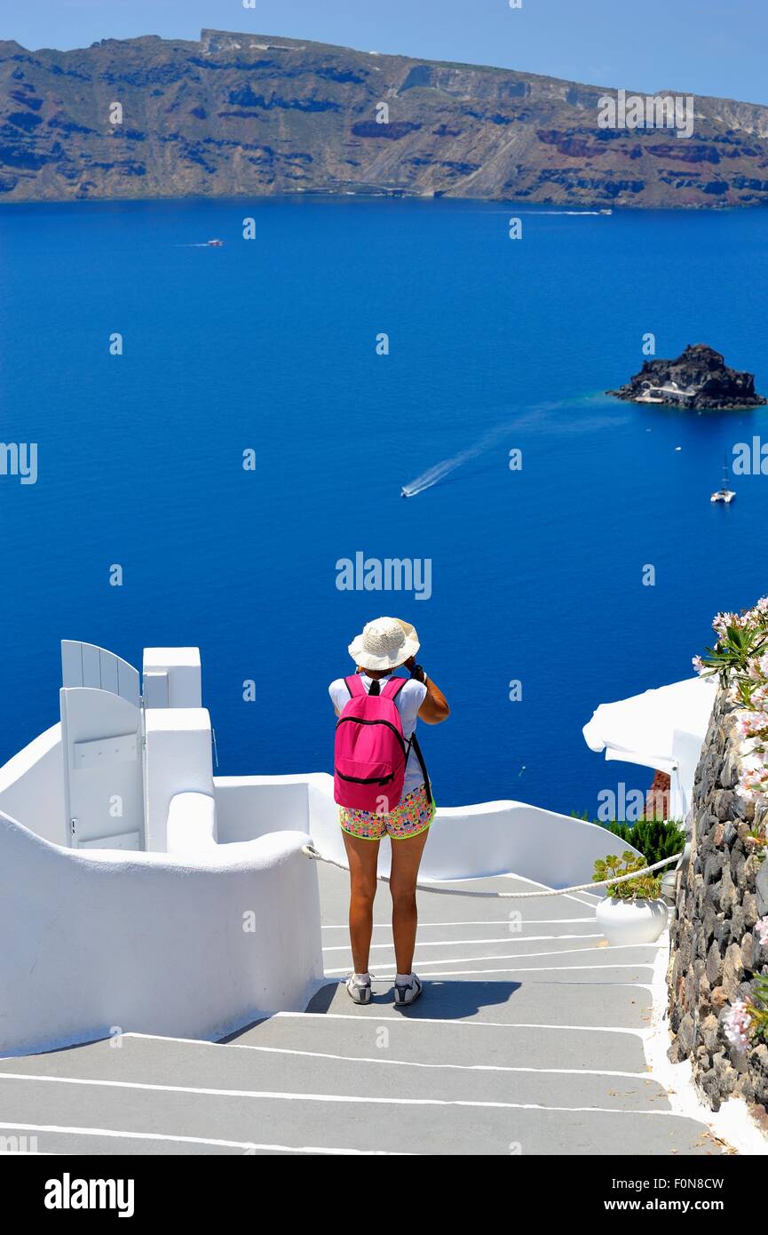 Eine weibliche Touristen fotografieren die Caldera von Santorini Griechenland Stockfoto