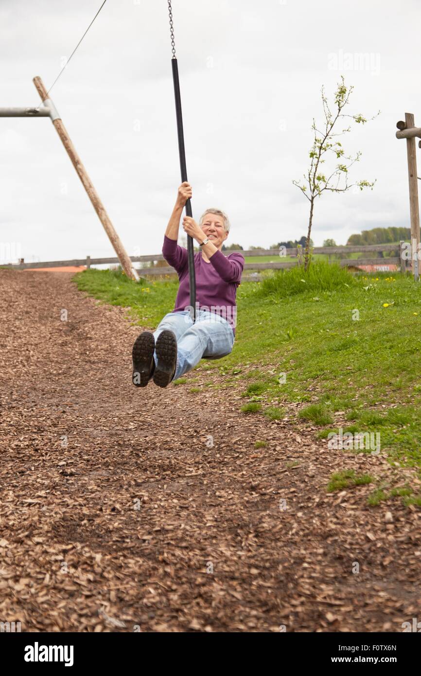 Ältere Frau spielt auf ZIP-Folie Stockfoto