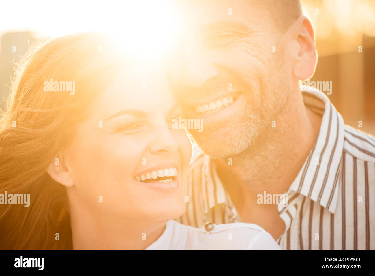 Glückliches Paar, tolle Zeit zusammen - bei Sonnenuntergang gegen die Sonne fotografiert Stockfoto