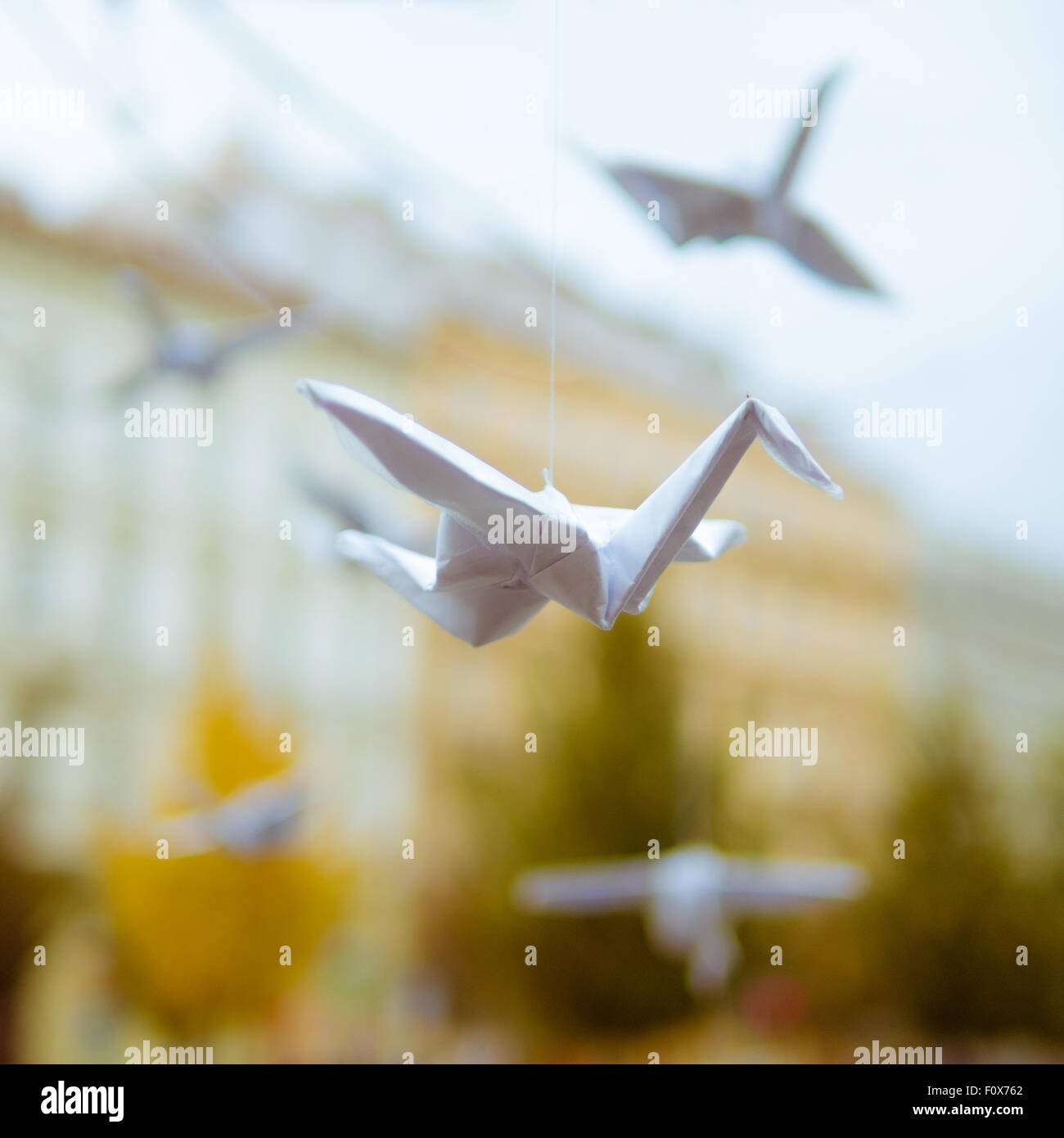 Origami-Kranich fliegt in der Stadt - street-art Stockfoto