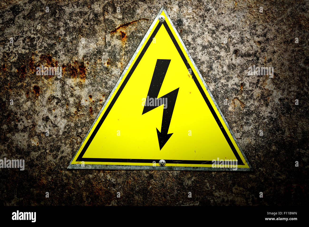 Alten gelbes Schild mit Hochspannung-Symbol Stockfoto