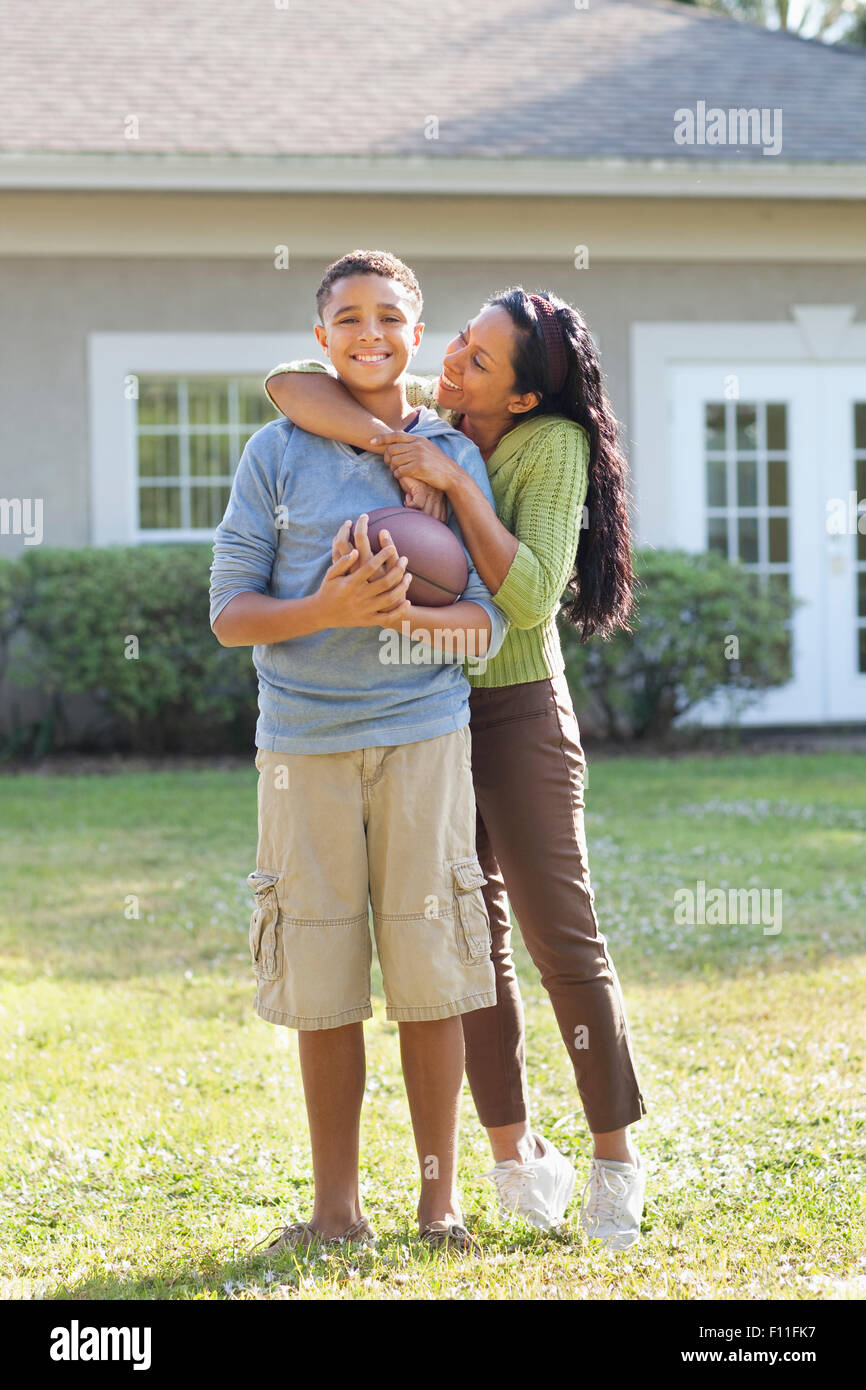 Mutter und Sohn umarmt im Hinterhof Stockfoto