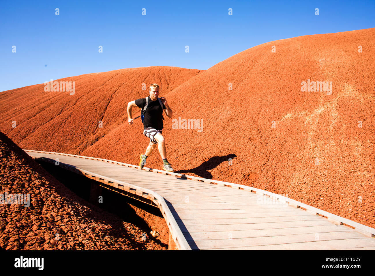 Kaukasischen Mann läuft auf Gehweg in einsamen Hügeln Stockfoto