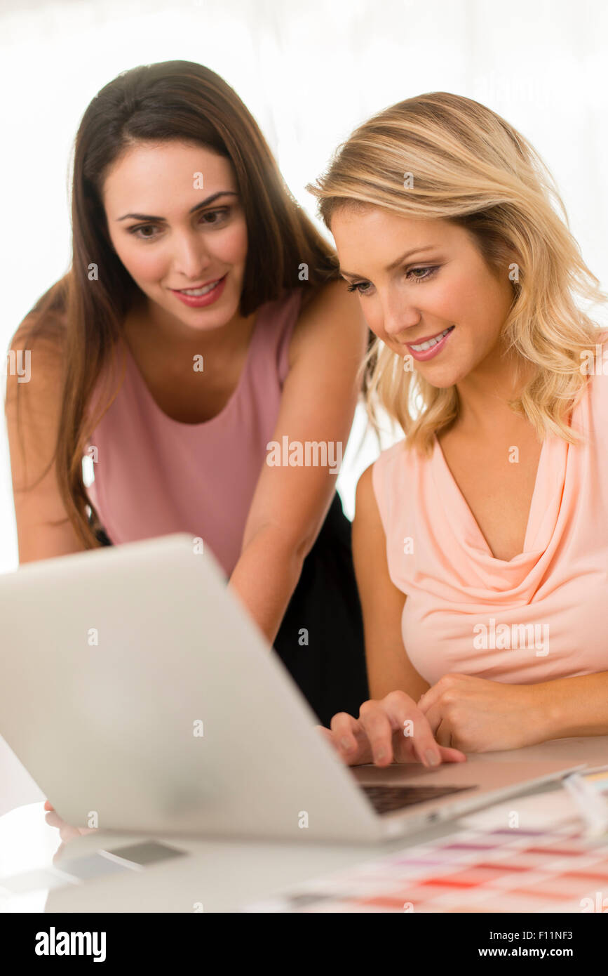 Unternehmerinnen mit Laptop am Tisch Stockfoto