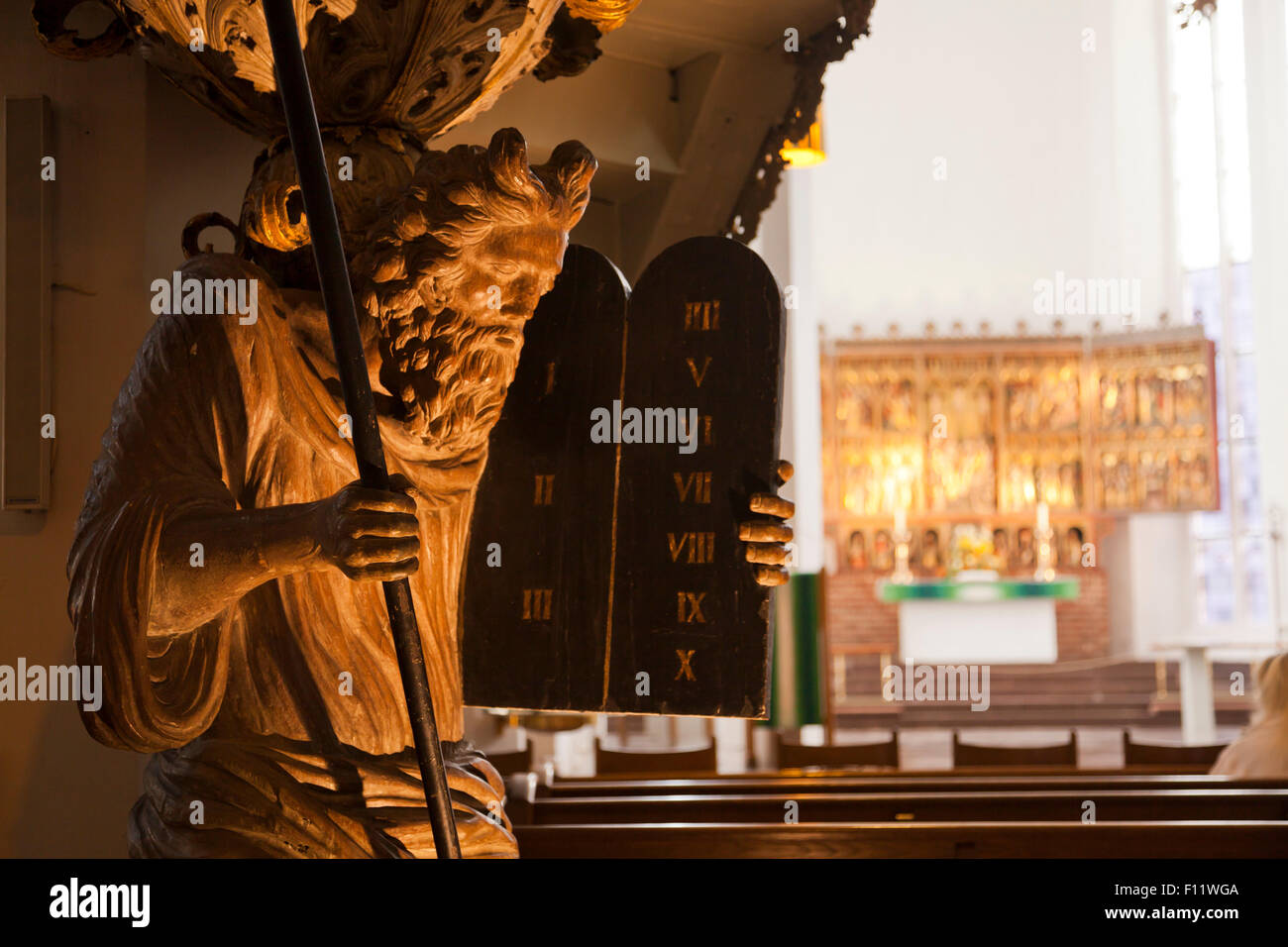 Statue von Moses mit den Gesetzestafeln und geflügelte Altar in der lutherischen St.-Nikolaus-Kirche, Kiel, Schleswig-Holstein, Deutsch Stockfoto