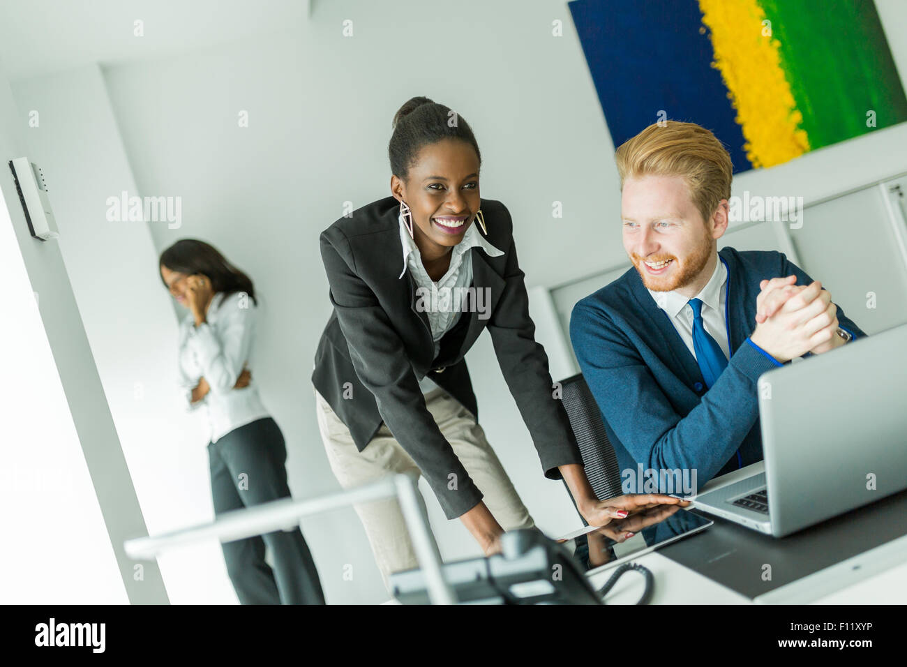 Geschäftsleute sprechen und Lächeln in einem Büro vor einem notebook Stockfoto