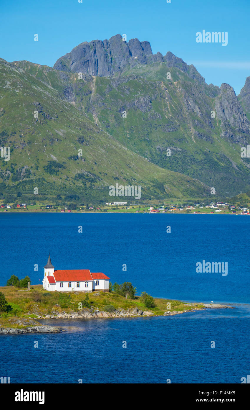 Weiße Kirche mit rotem Dach in den Bergen und Fjord Einstellung, Lofoten, Norwegen Stockfoto