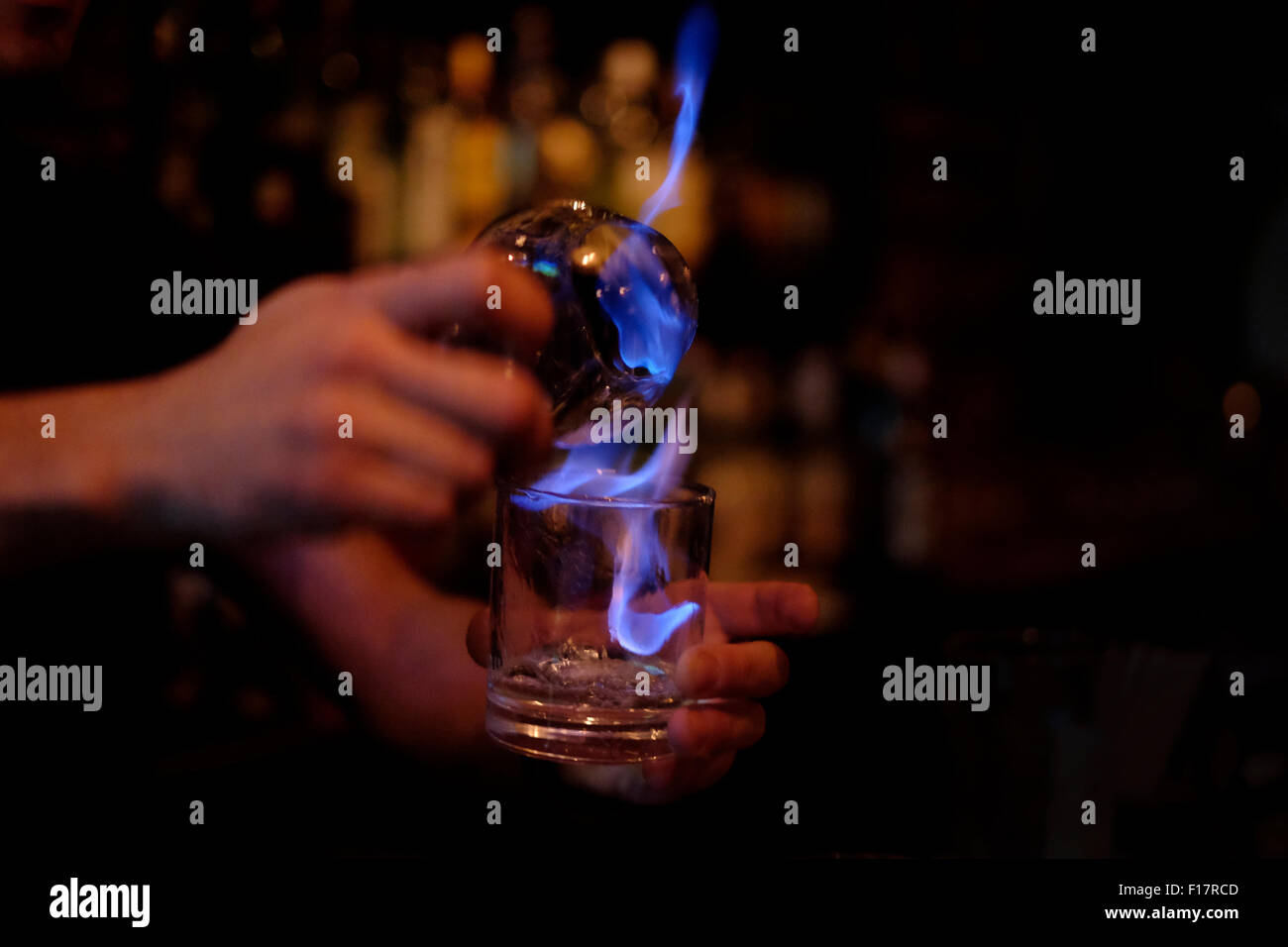 Ein Barkeeper machen einen flammenden cocktail in einer Bar Stockfoto